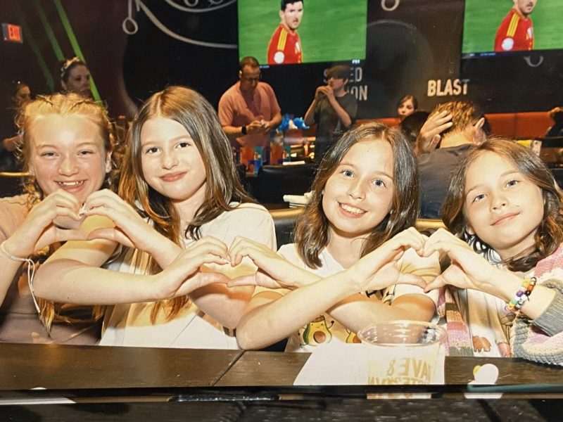 Children were seating while having love gesture