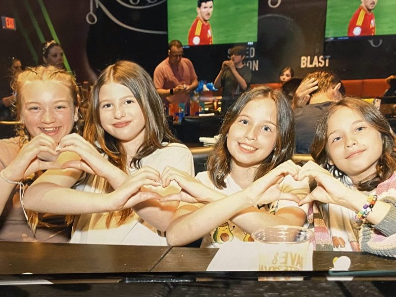 Children were seating while having love gesture